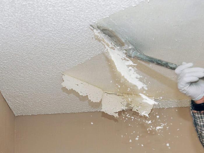 Popcorn texture being removed from ceiling and prepped for a refinish.